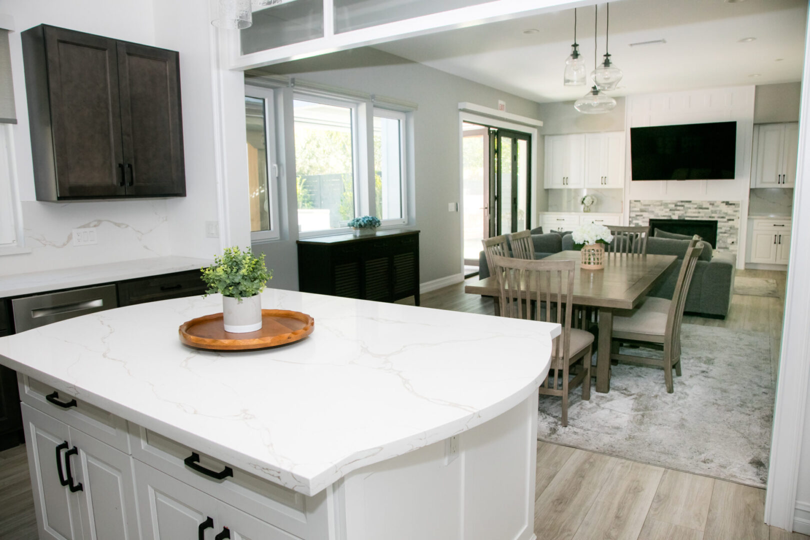 A kitchen with white cabinets and a large island.