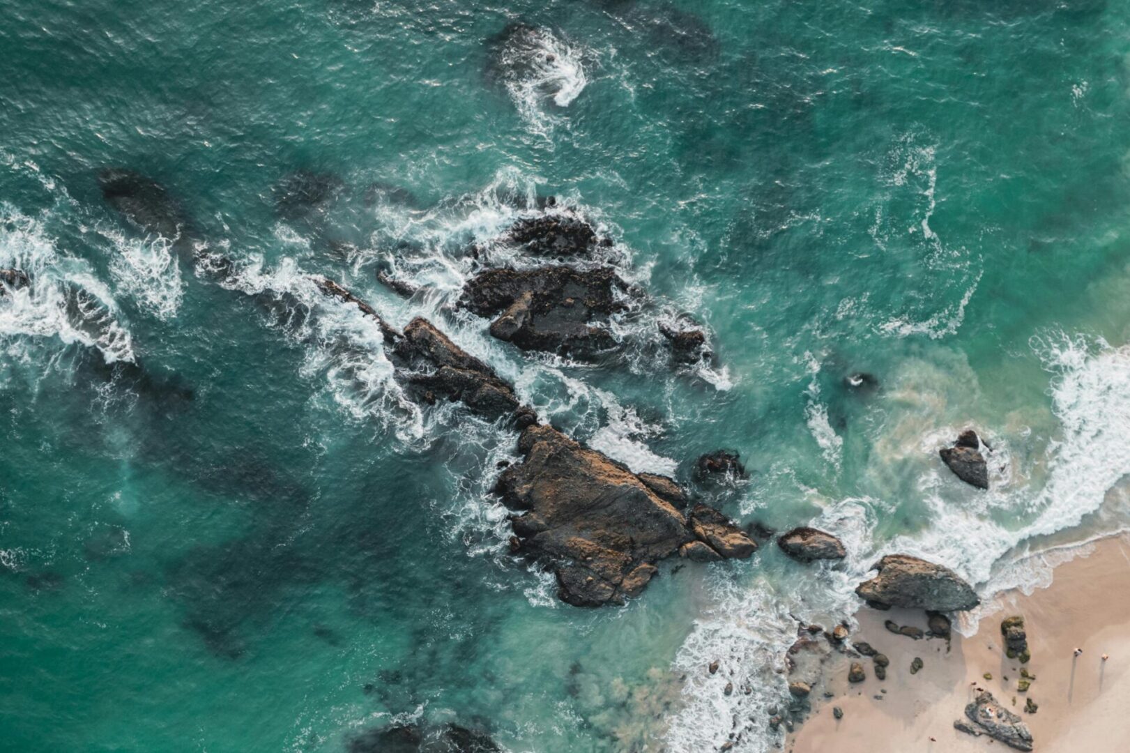 A body of water with rocks and waves in it